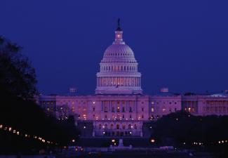 View of the exterior of the U.S. Capitol at night.